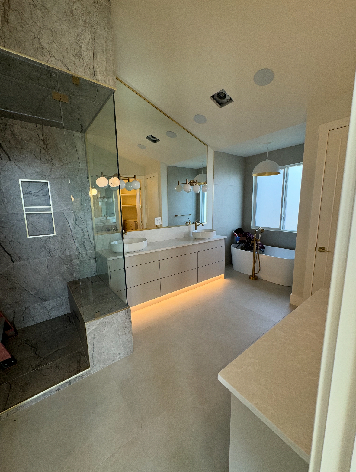 Primary bathroom with marble shower and freestanding tub